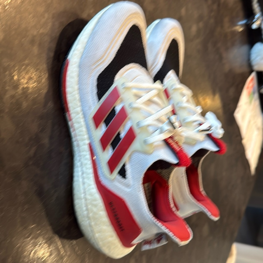 Adidas Ultraboost Husker athletic shoes.